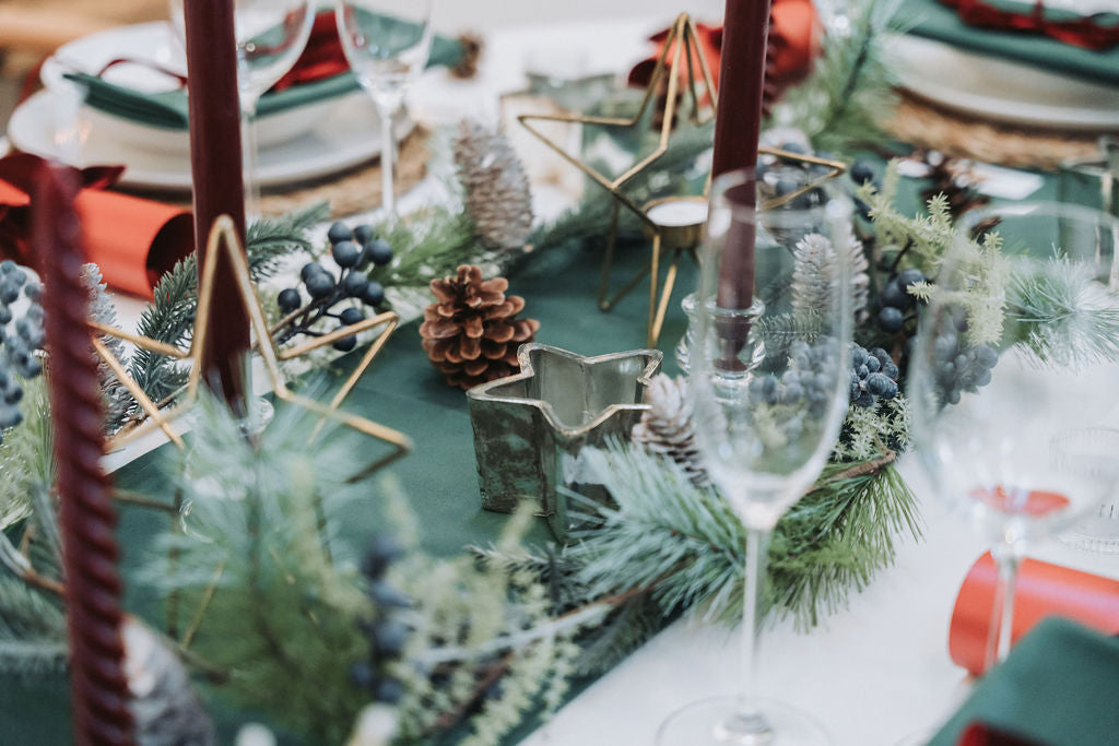 Close-up of copper tealight holder with perforated star design glowing warmly.