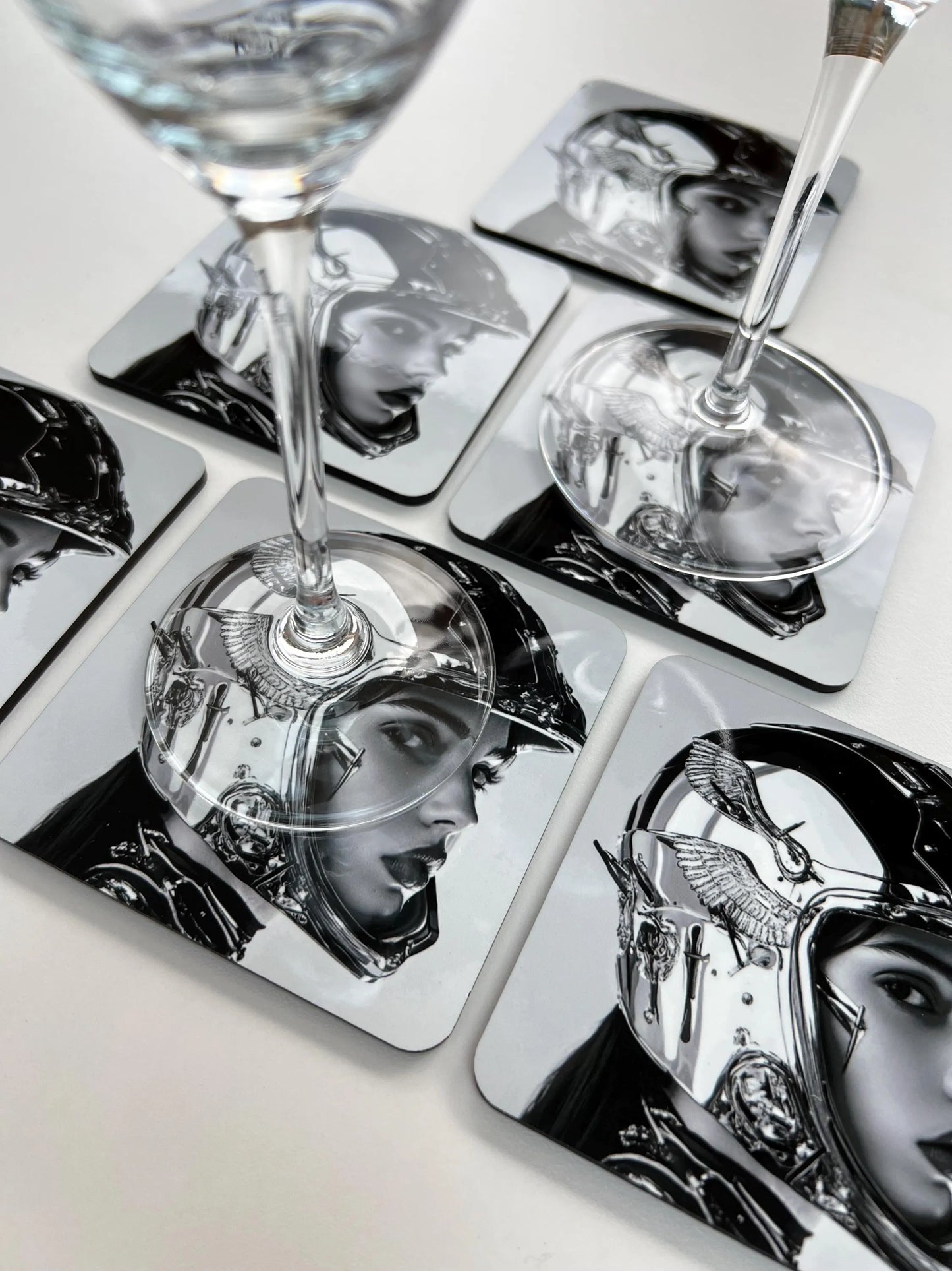 Set of coasters with black and white images of people wearing helmets on a white surface.
