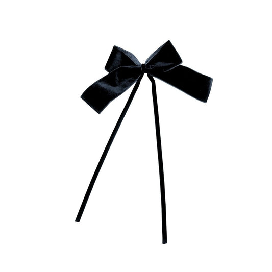 Black velvet bow with two thin black velvet ribbon on a white background