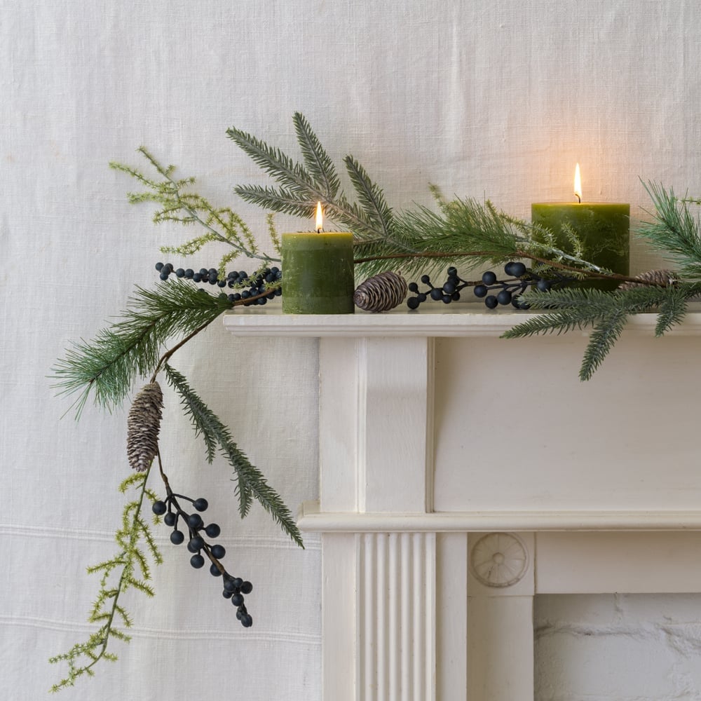 Christmas Garland with Christmas Green Candles on Rustic Shelve