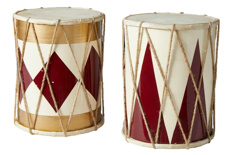 Two decorative hand drums shown side by side on a plain white background. Each drum has a white drumhead, beige rope tensioning, and a body with alternating cream and deep red geometric panels, plus light wood-toned bands near the top and bottom.
