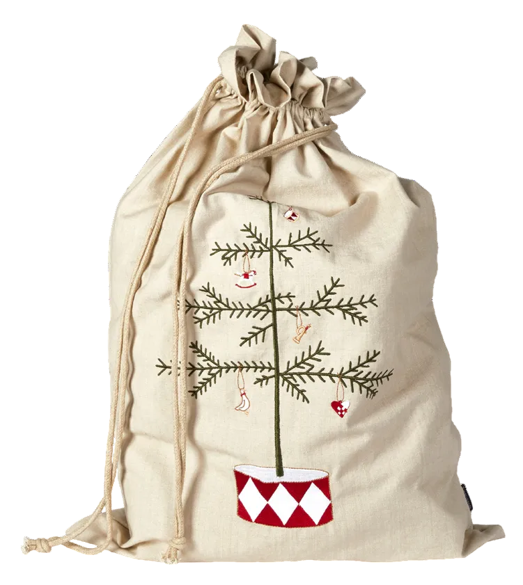 A beige canvas drawstring gift bag featuring an embroidered Christmas tree with a smiling face and ornaments, set against a plain white background.