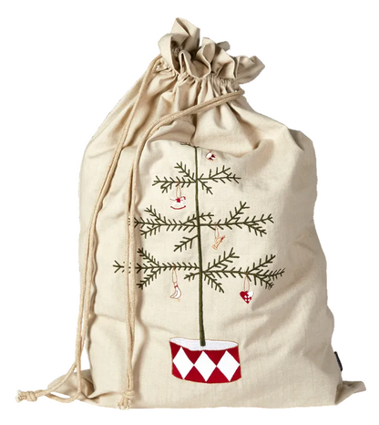 A beige canvas drawstring gift bag featuring an embroidered Christmas tree with a smiling face and ornaments, set against a plain white background.
