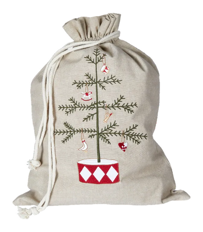 A beige linen Christmas stocking bag with a drawstring closure, featuring an embroidered pine tree with red and white ornaments and a red-and-white diamond-patterned pot.