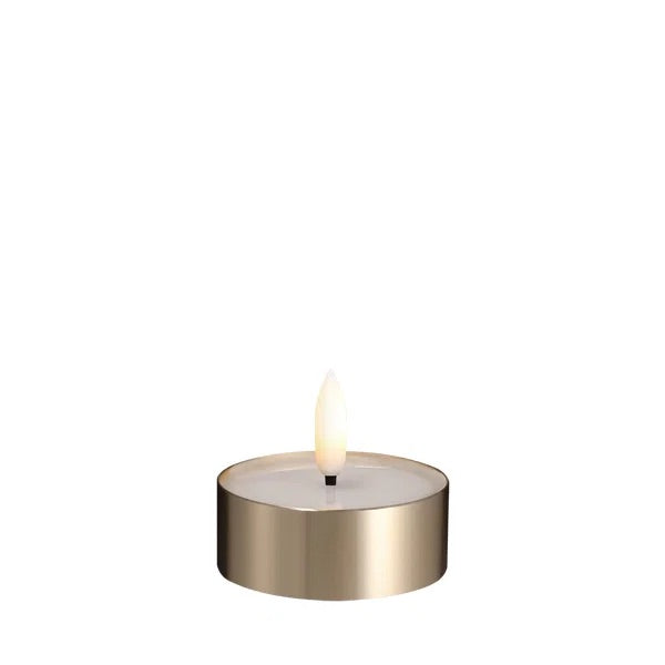 Tealight candle with brass holder on a white background