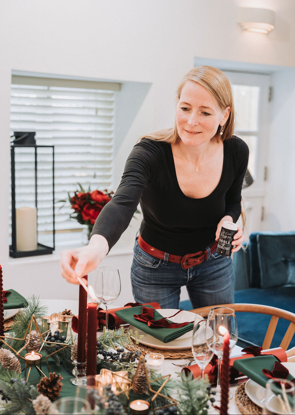 Noble & Nordic founder, Inge Nielsen,  setting a festive table with candles and decorations