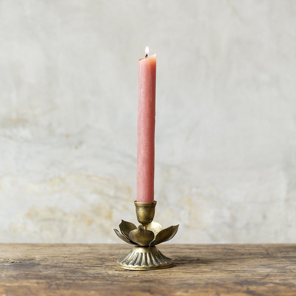 Close-up of brass lotus candle holder showing detailed petals and warm metallic finish.