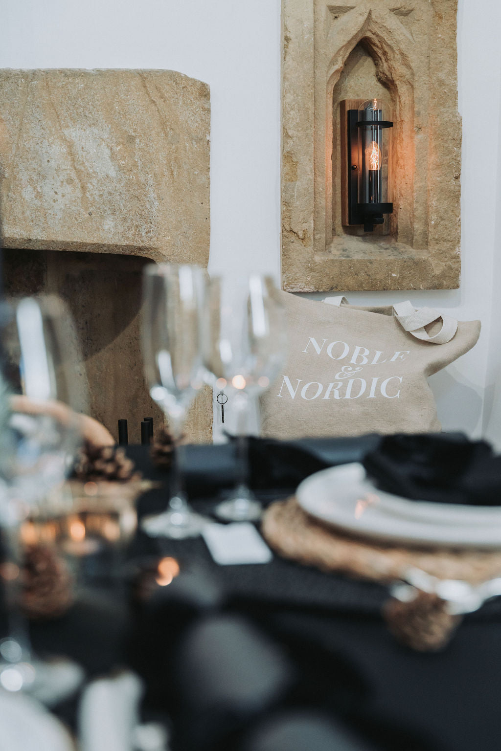 Nordic-themed table setting with candles and decor in a rustic interior by Noble & Nordic.