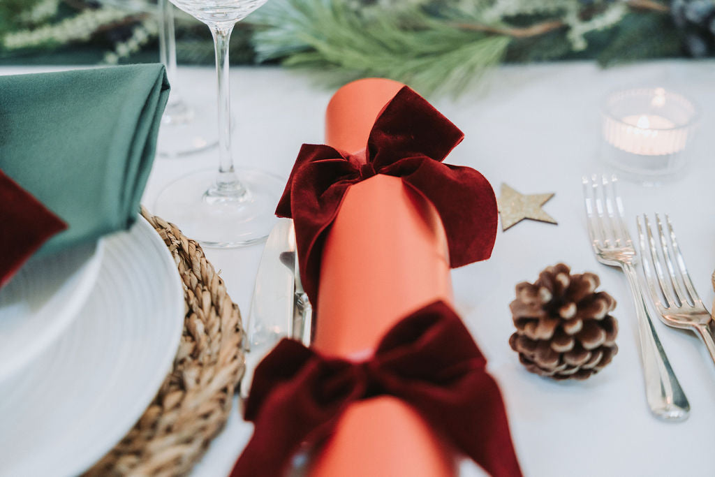 Elegant Nordic-inspired Christmas dinner table with candles and natural textures.