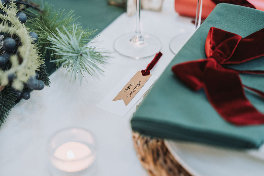 Nordic Christmas table styled in pine green with velvet ribbons by Noble & Nordic