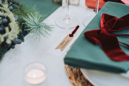Nordic Christmas table styled in pine green with velvet ribbons by Noble & Nordic