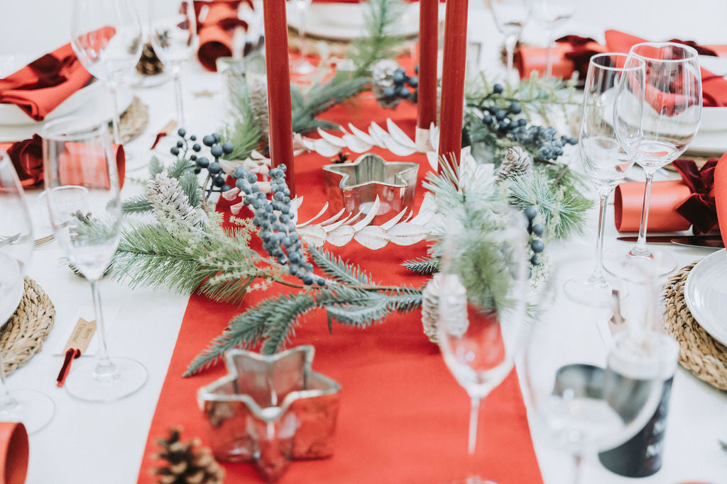 Burgundy Velvet bows and flame Christmas tablescape with pine foliage garland  and star tea-light candleholder by Noble & Nordic.