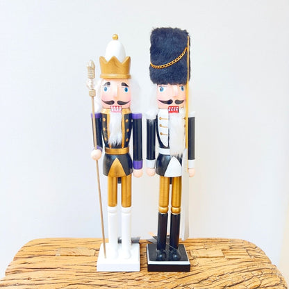 Elegant black and gold nutcracker soldiers with regal white details.
