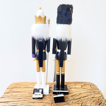 Classic wooden nutcrackers with gold crowns and fur hats.