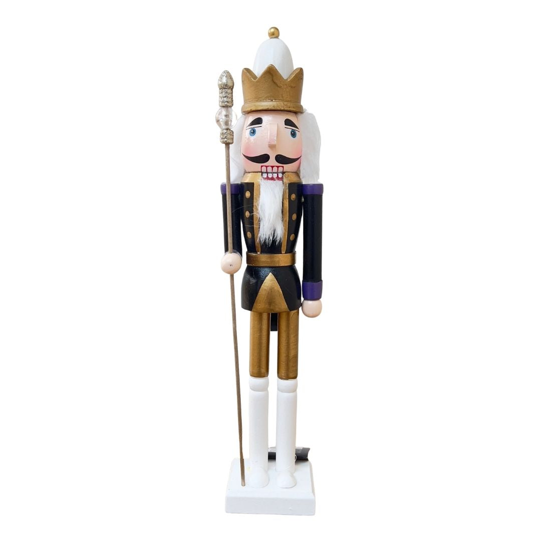 Wooden nutcracker figurine dressed as a king on a white background