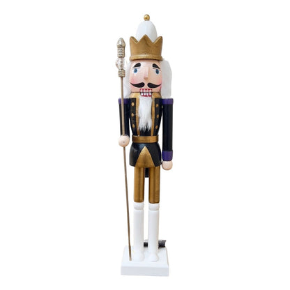 Wooden nutcracker figurine dressed as a king on a white background