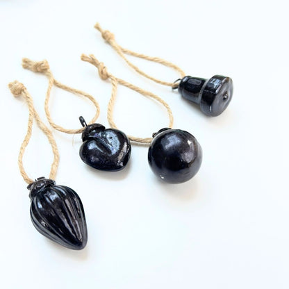 Black mini Christmas baubles on white background