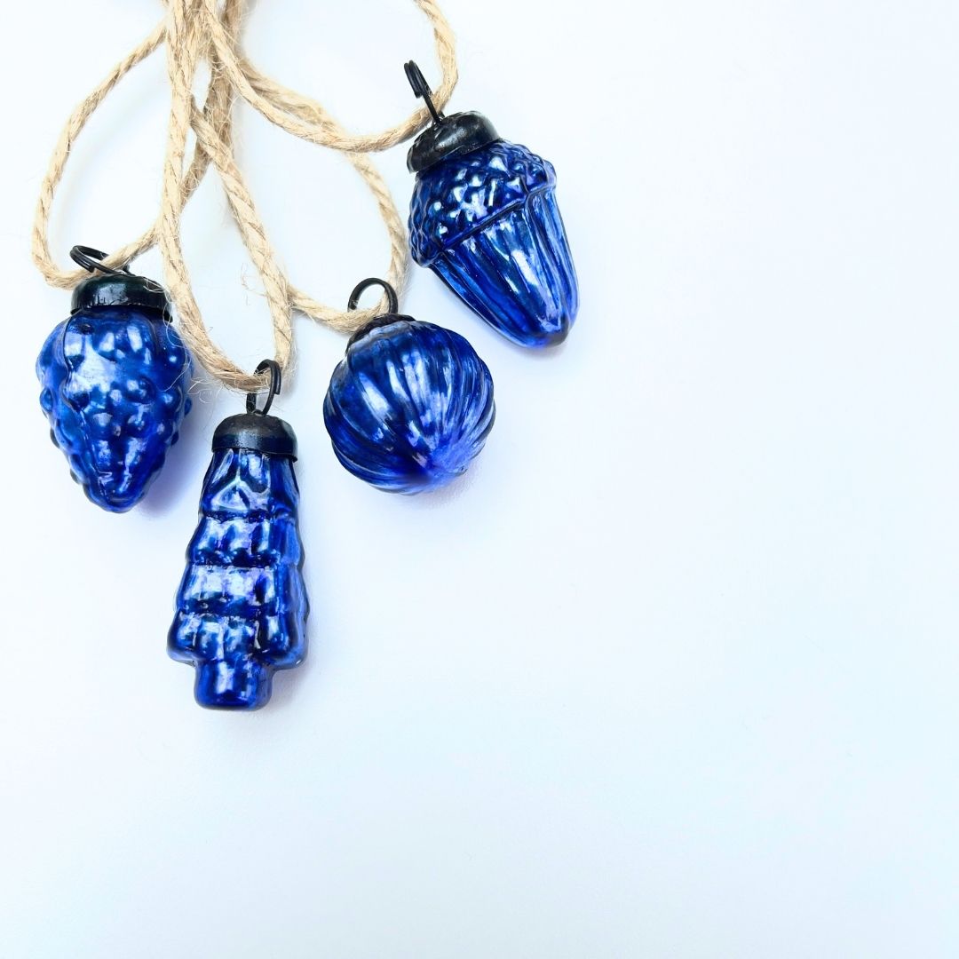 Blue mini Christmas baubles mixed-shaped on white background