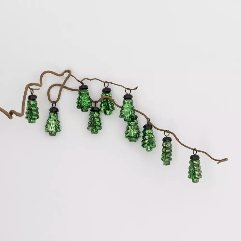 Set of green glass Christmas tree baubles displayed on a natural branch — Nordic-inspired festive décor by Noble & Nordic.