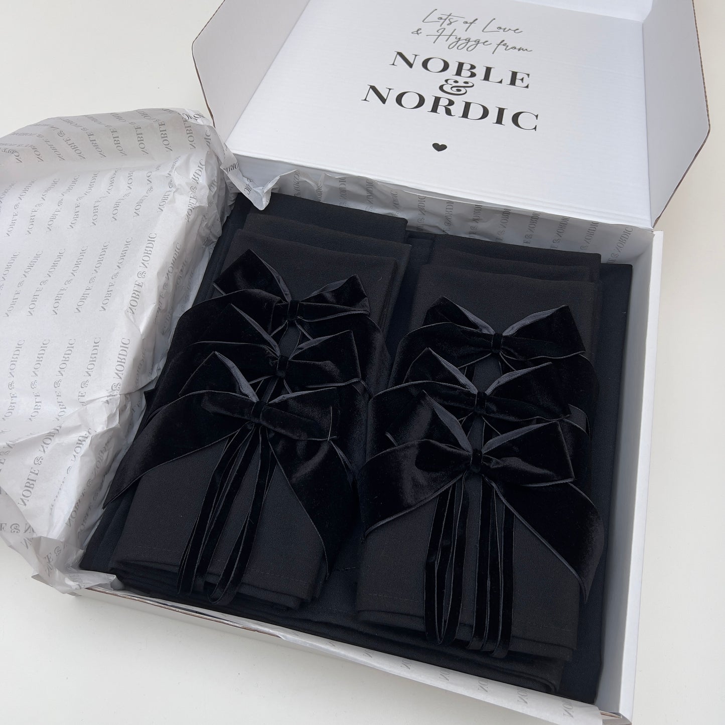 Black table linen Signature Set in a box with 'Noble & Nordic' branding.