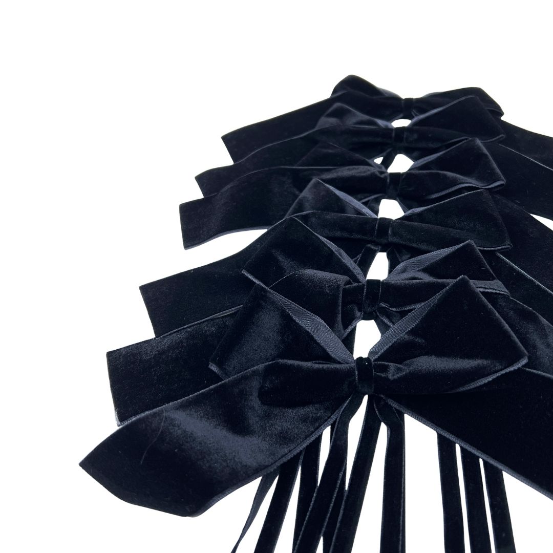 Set of black velvet bows on a white background