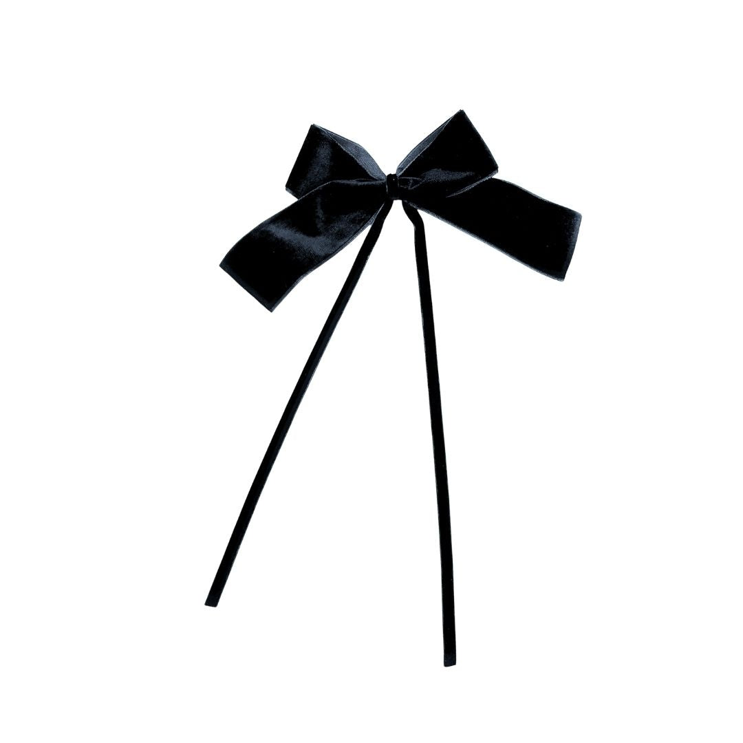 Black velvet bow with two thin black velvet ribbon on a white background