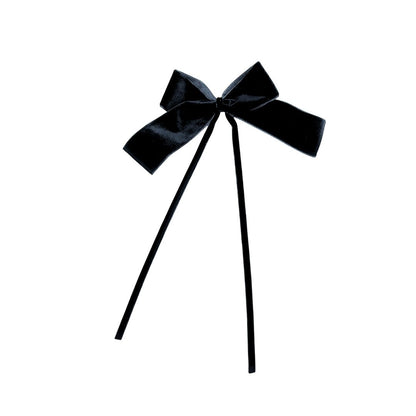 Black velvet bow with two thin black velvet ribbon on a white background