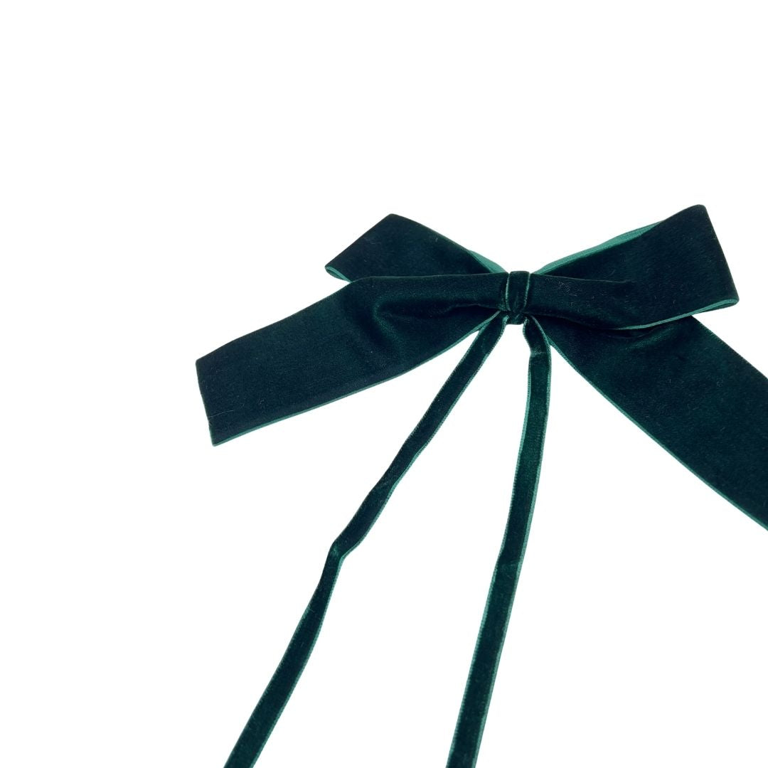 Dark green velvet bow on a white background