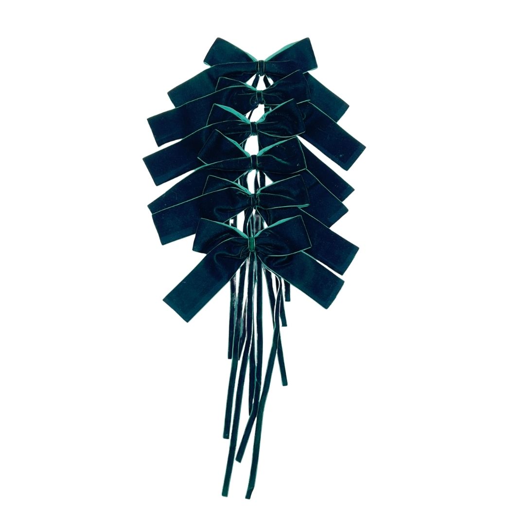 Dark Green velvet bows with ribbon string on a white background