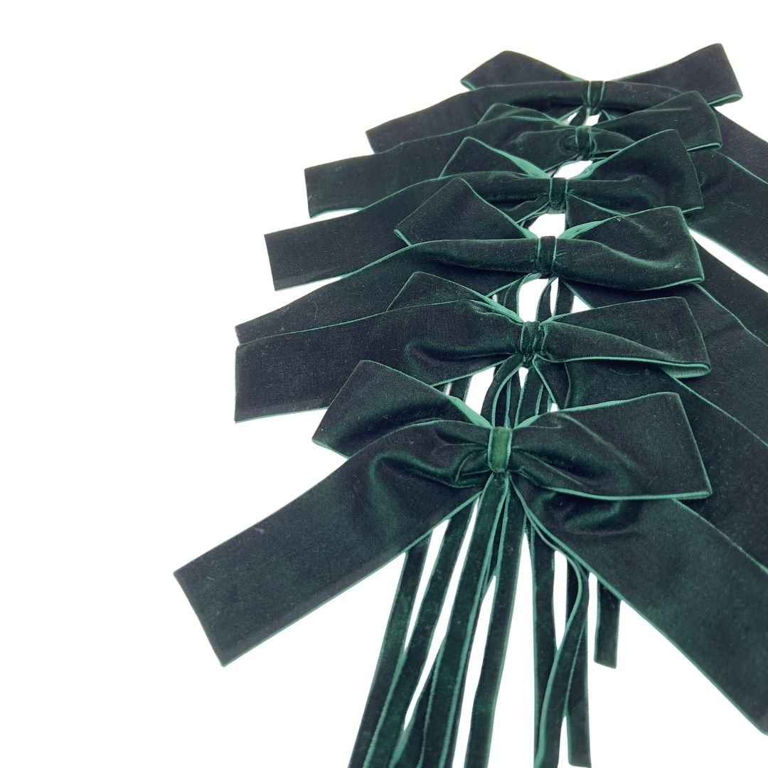 Set of 6 green velvet bows on a white background