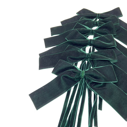 Set of 6 green velvet bows on a white background