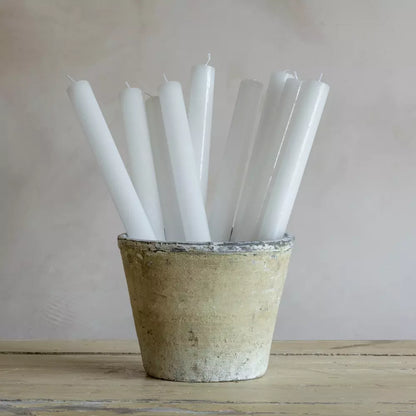 Elegant white dinner candles styled in a rustic stone pot — minimalist Nordic design for timeless home styling by Noble & Nordic.
